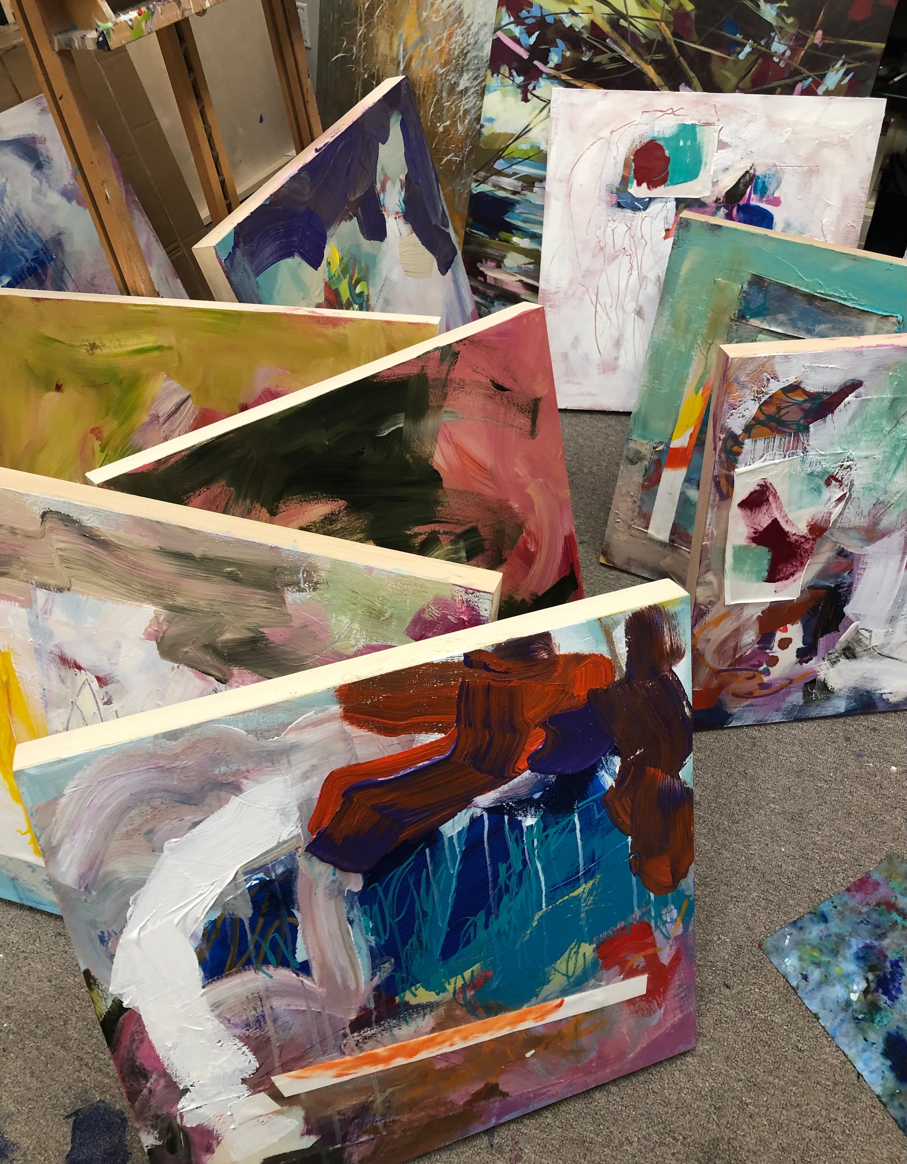 Shane Norrie studio canvases stacked against a wall
