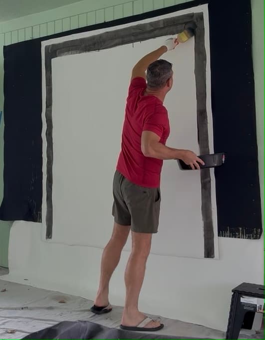 Andrew Lennon painting a large canvas in the studio
