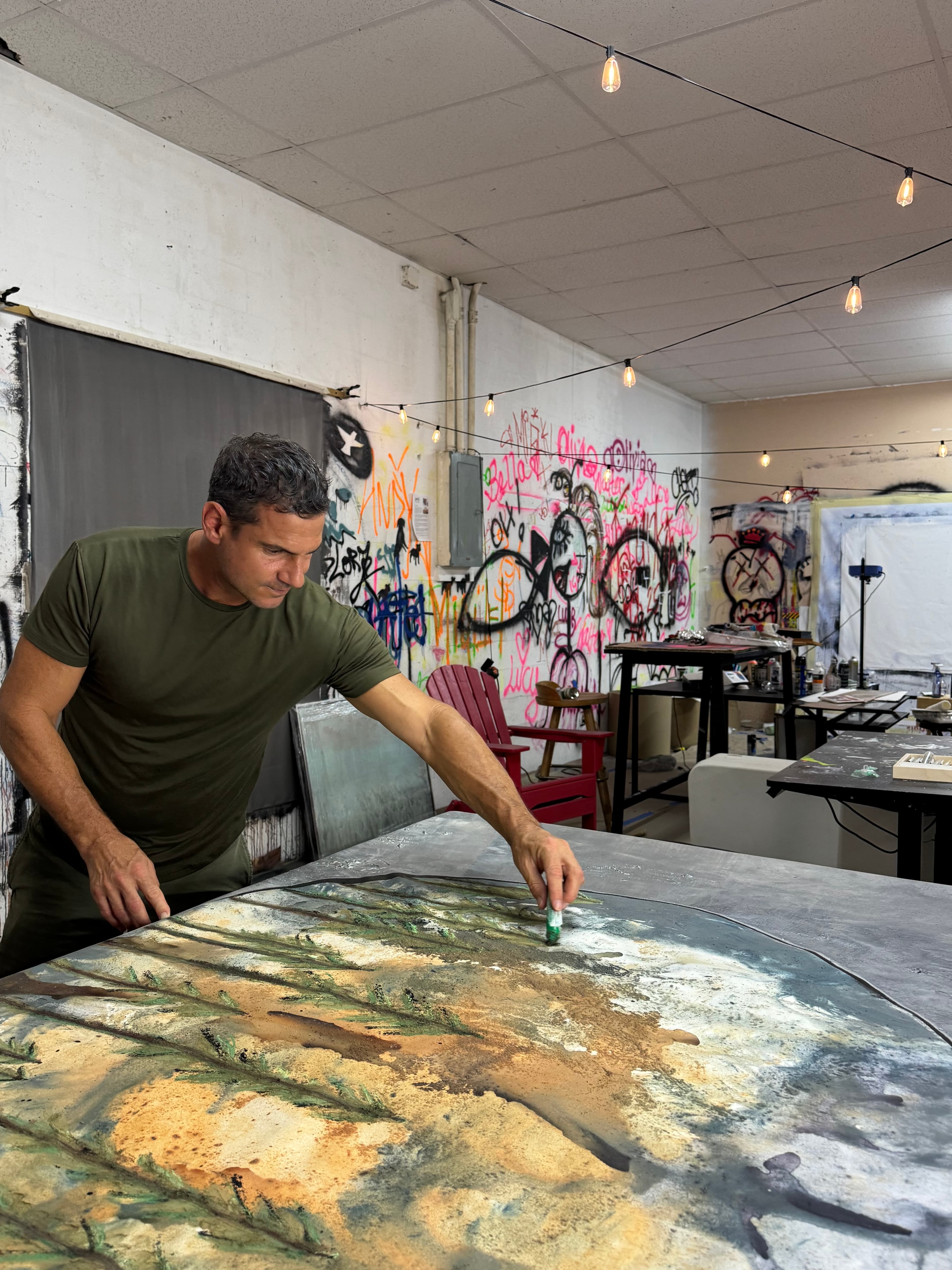 Andrew Lennon working on a painting in his studio