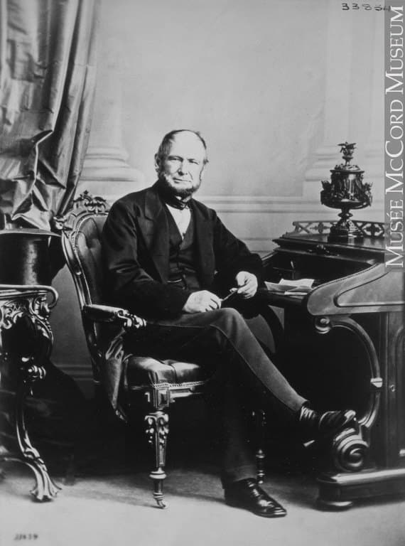 Harrison Stephens seated at a carved desk in an oval portrait