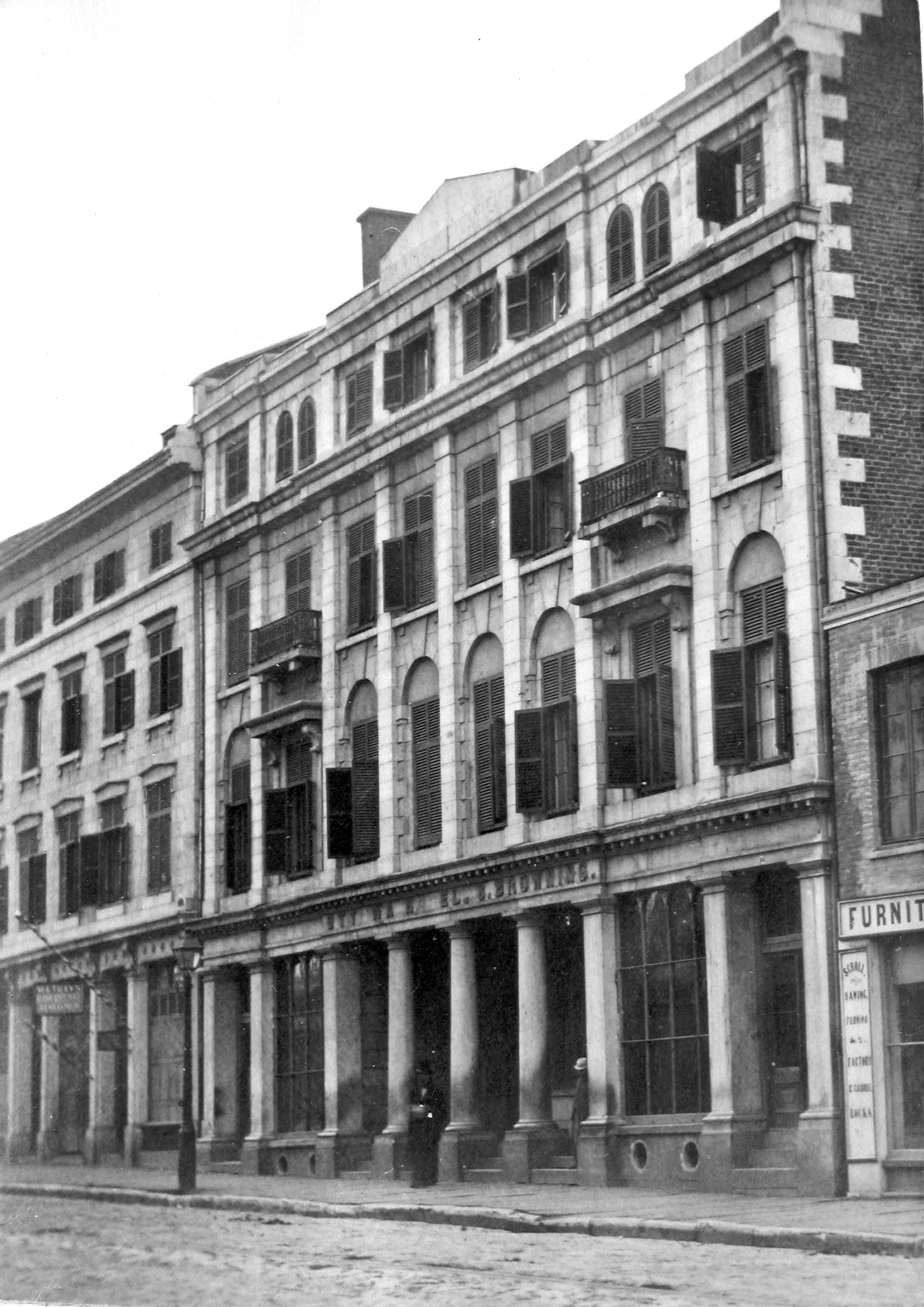 Black-and-white photograph of the Ottawa Hotel colonnade and shuttered windows on Great St. James Street