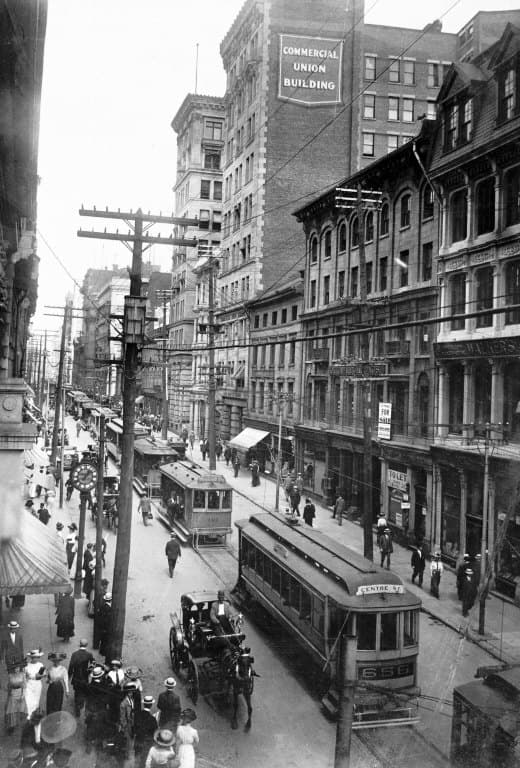 Elevated view of St. James Street with Montreal streetcars, carriages, and the Commercial Union Building