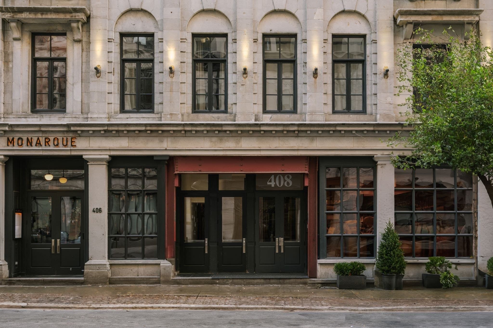 Street-level facade of Nester Finn Square Victoria with Monarque and the 408 entrance