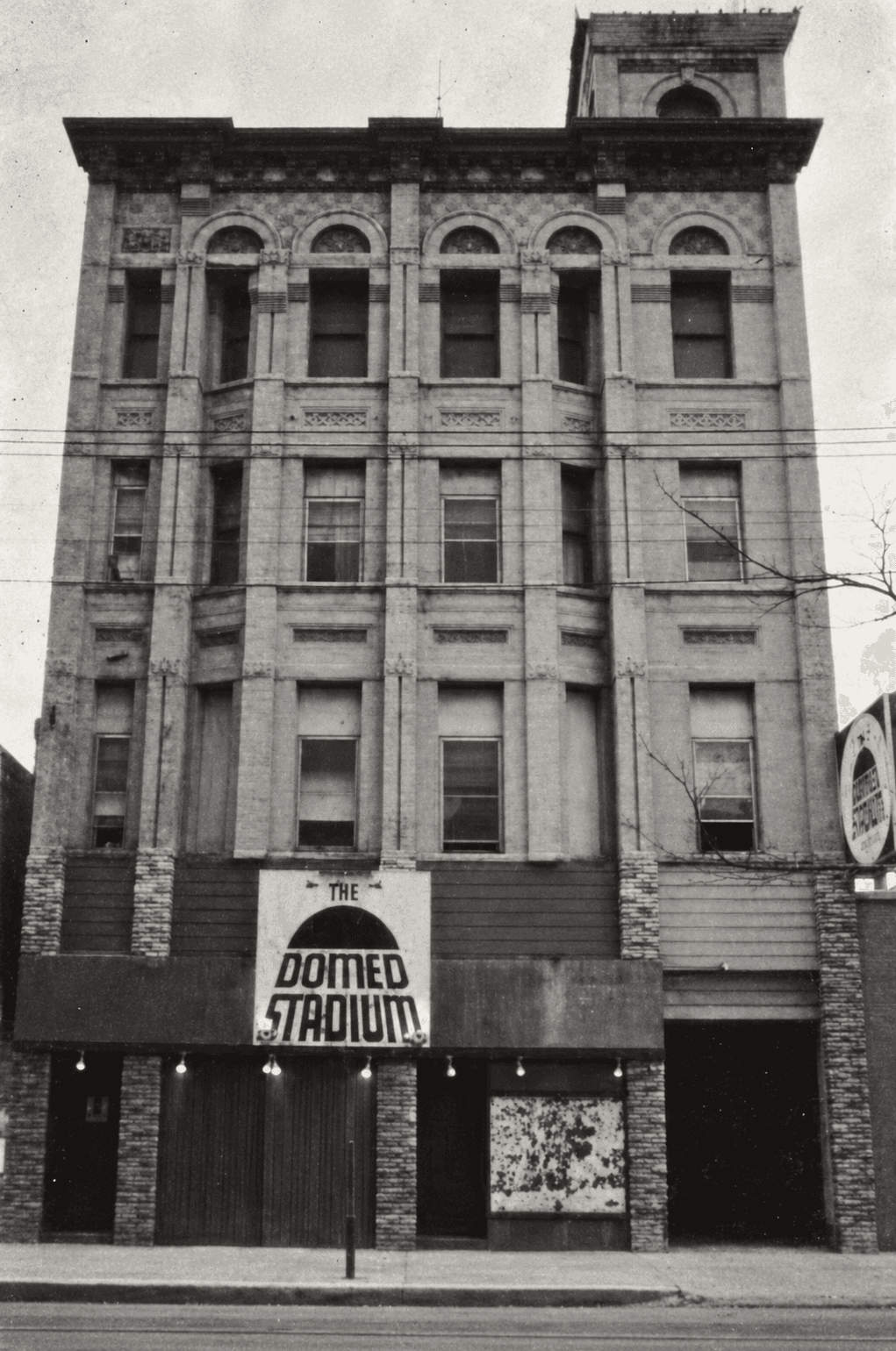 Vintage photograph of Nealon House at Nester Finn St. Lawrence Market in Toronto, showing the Domed Stadium Hotel storefront and Romanesque Revival facade